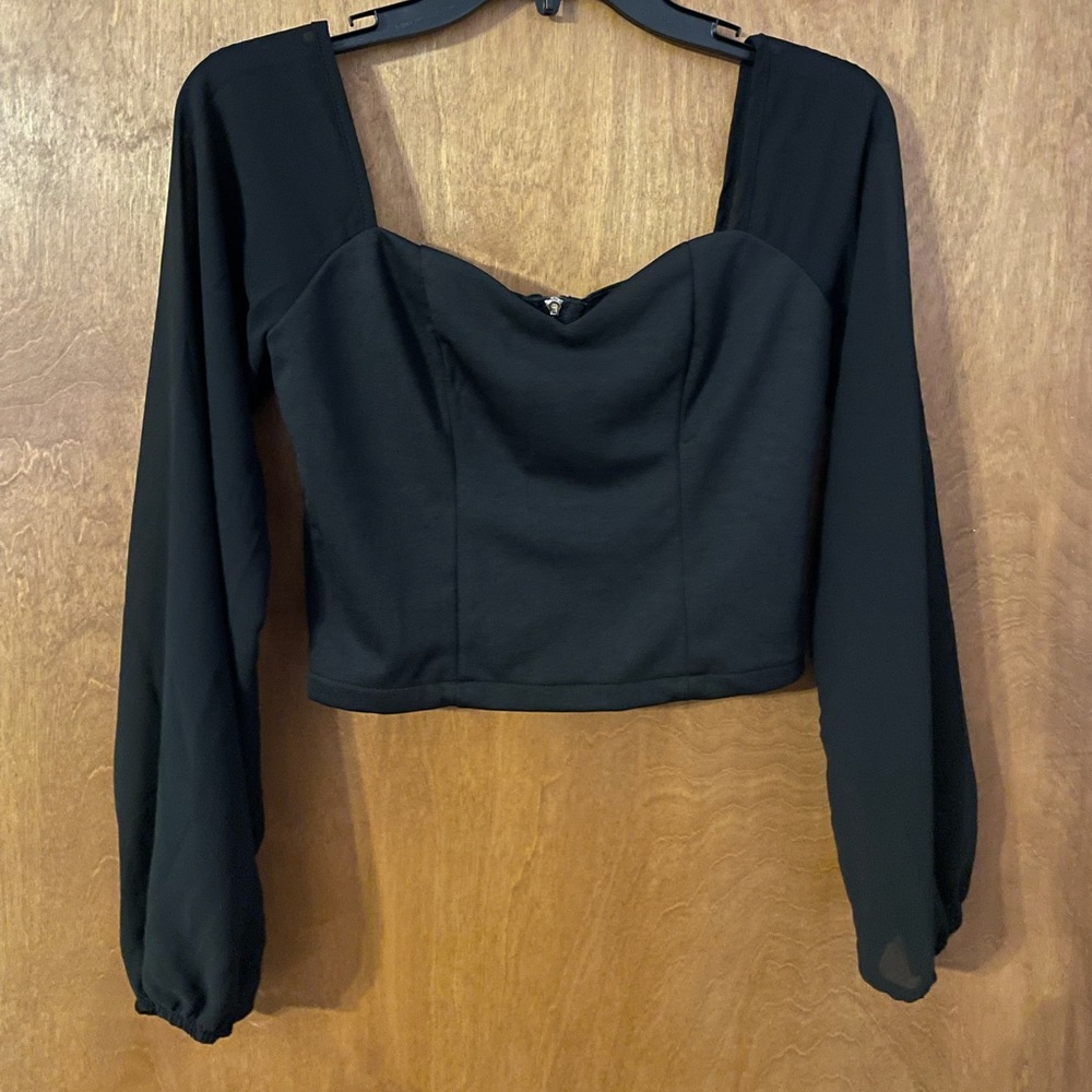 Small, black sweetheart neckline with transparent sleeves